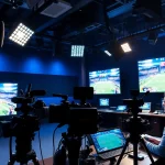 Engaging sports broadcasting studio featuring advanced equipment and live action displays.